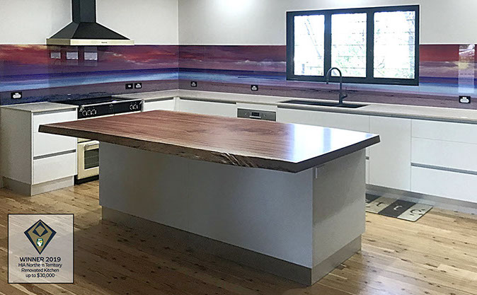 Kitchen with solid timber (Mahogany) island benchtop and printed glass splashback.